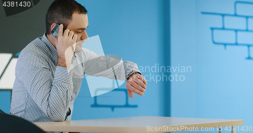 Image of Senior businessman  using cell phone at  stratup office