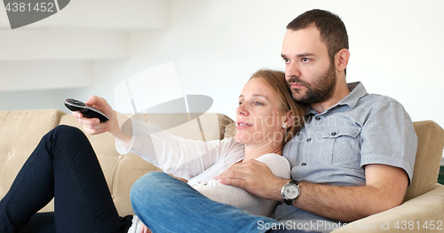 Image of senoior couple watching tv in modern villa