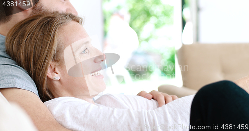 Image of senoior couple watching tv in modern villa