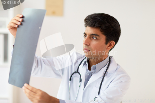 Image of doctor looking at spine x-ray scan at clinic