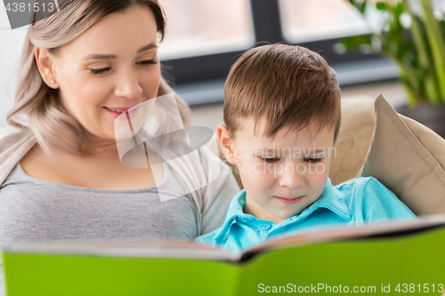 Image of close up of happy mother and son reading book