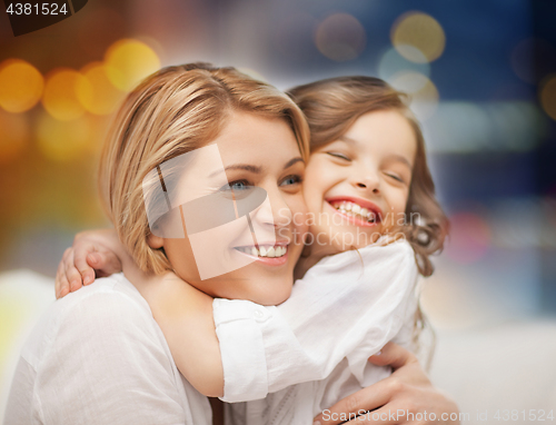 Image of happy mother and little daughter hugging