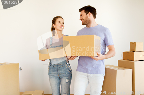 Image of happy couple with boxes moving to new home