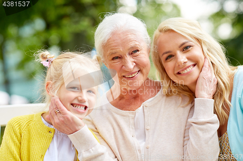 Image of woman with daughter and senior mother at park