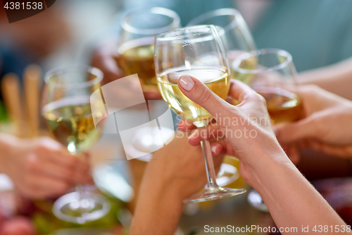 Image of hands clinking wine glasses