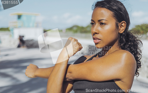 Image of Pretty black girl warming up in park