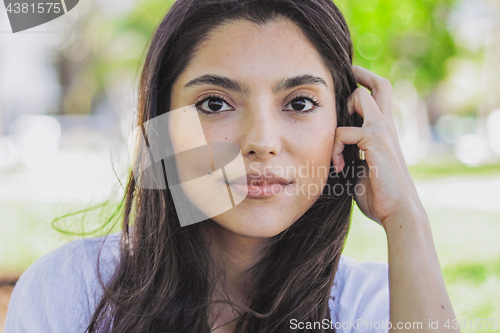 Image of Attractive brunette in summertime looking at camera