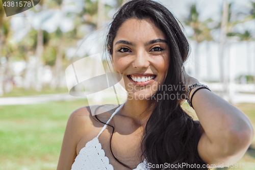 Image of Content bright girl touching hair in sunshine