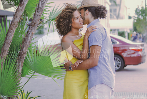 Image of Couple standing and embracing on the street