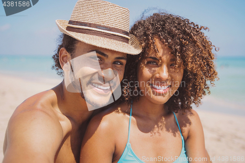 Image of Couple looking at camera on beach