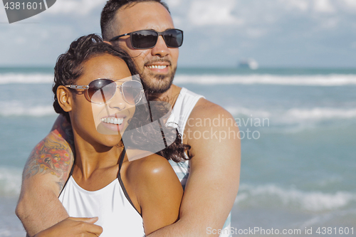 Image of Embracing stylish couple on ocean shore