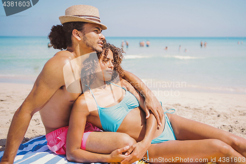 Image of Couple resting on beach
