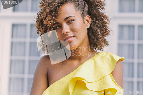 Image of Ethnic woman in yellow dress