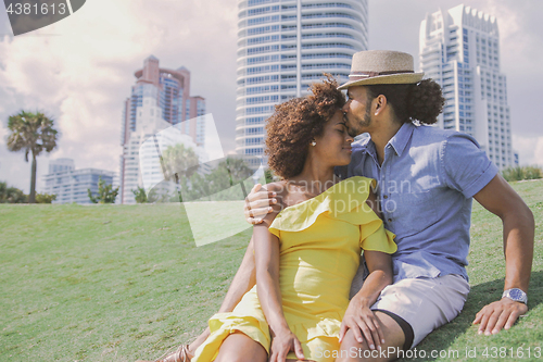 Image of Couple embracing and kissing in park