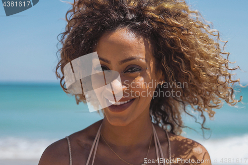 Image of Beautiful ethnic woman in tropical sunshine