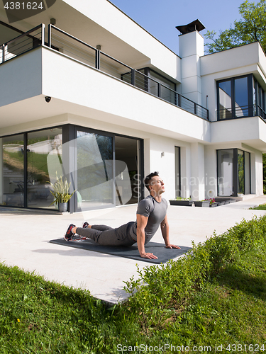 Image of man doing morning yoga exercises