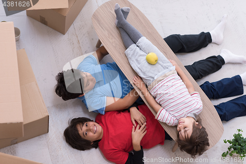 Image of boys with cardboard boxes around them top view