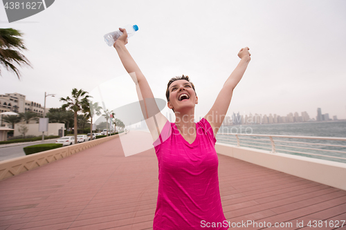 Image of young woman celebrating a successful training run