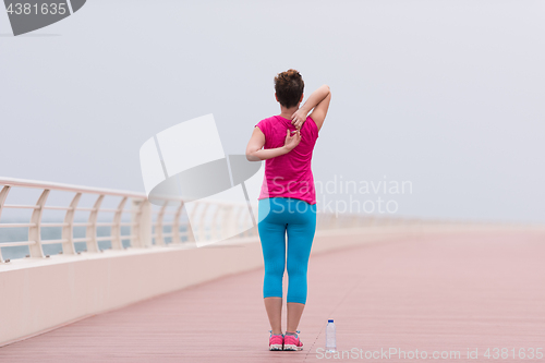 Image of woman stretching and warming up on the promenade