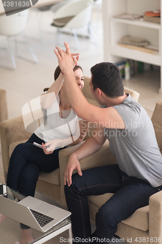 Image of happy young couple buying online