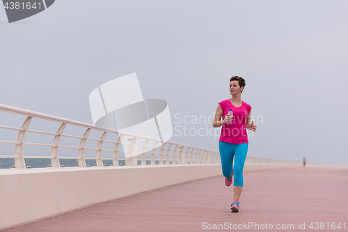 Image of woman busy running on the promenade