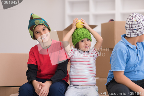 Image of boys with cardboard boxes around them