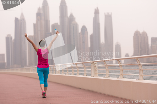 Image of young woman celebrating a successful training run