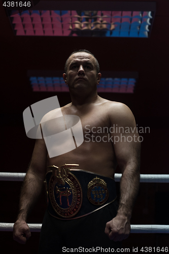 Image of kick boxer with his championship belt