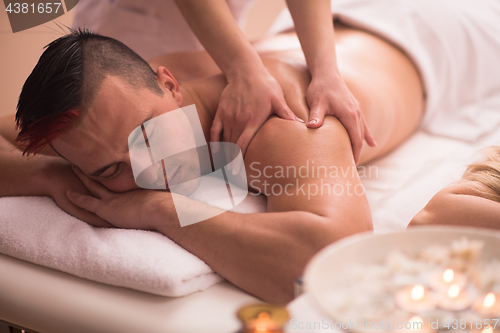 Image of young man having a back massage