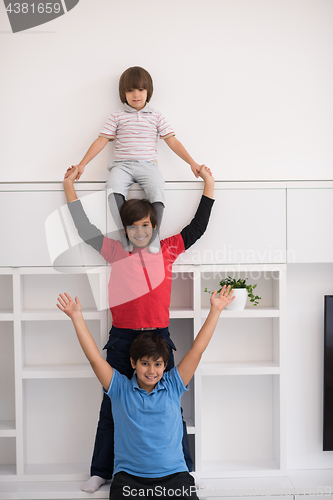 Image of young boys posing line up piggyback