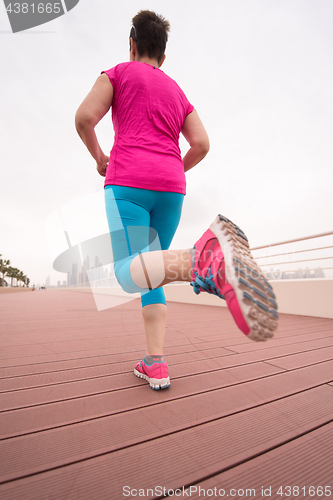 Image of woman running on the promenade