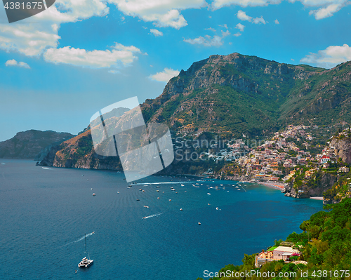 Image of One of the best resorts of Italy with old colorful villas on the steep slope, nice beach, numerous yachts and boats in harbor and medieval towers along the coast, Positano.