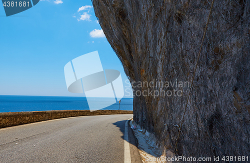 Image of Asphalt road. Colorful landscape with beautiful mountain road with a perfect asphalt. High rocks, blue sky at sunrise in summer. Vintage toning. Travel background. Highway at mountains