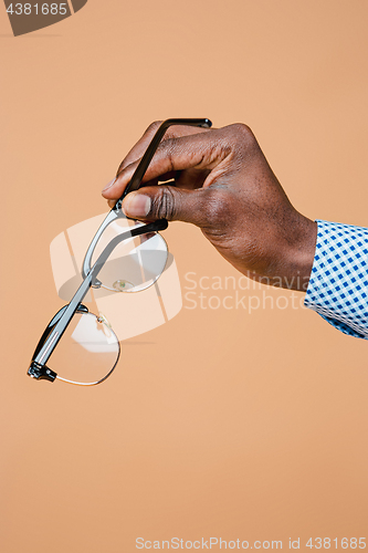 Image of Male hand holding glasses, isolated