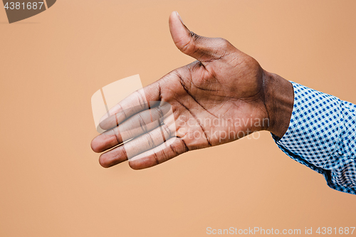 Image of Handshake. Hands of businessman isolated on brown background