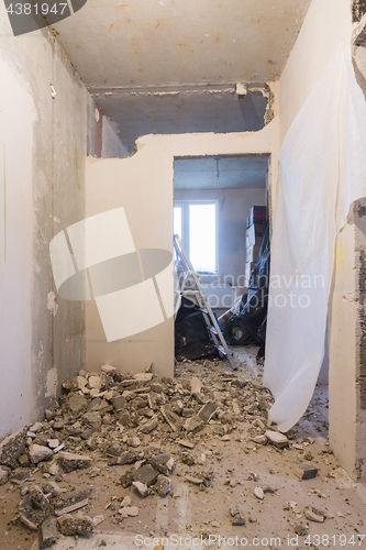 Image of Dismantling the walls in the apartment, in the background are boxes with things