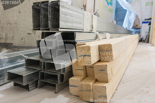 Image of Building materials - wooden bars and metal profiles, on the floor in the apartment