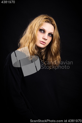 Image of Portrait of a girl on a black background with bright makeup