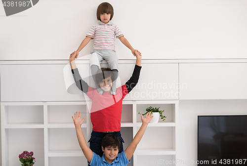 Image of young boys posing line up piggyback