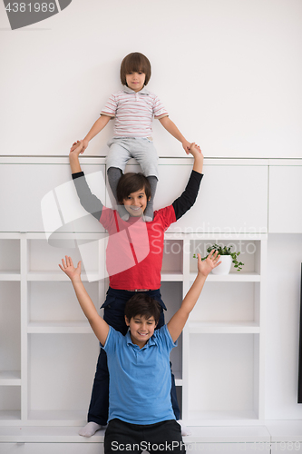 Image of young boys posing line up piggyback