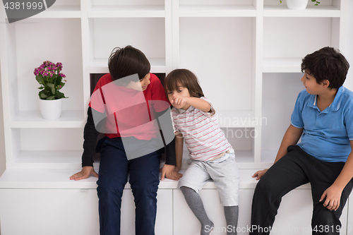 Image of young boys posing on a shelf