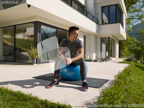 Image of man doing morning yoga exercises