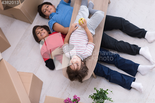 Image of boys with cardboard boxes around them top view