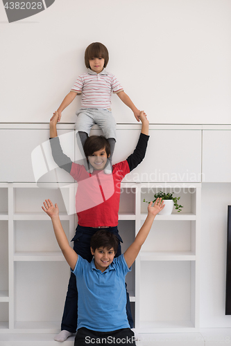 Image of young boys posing line up piggyback