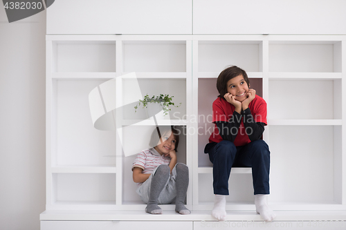 Image of young boys posing on a shelf