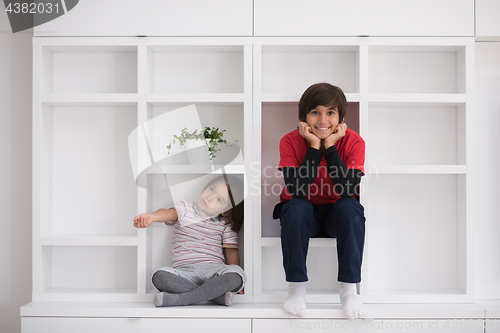 Image of young boys posing on a shelf