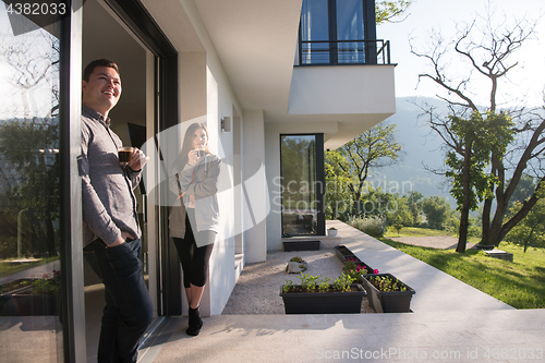Image of couple enjoying on the door of their luxury home villa