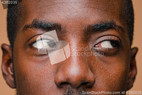 Image of Positive thinking African-American man on brown background