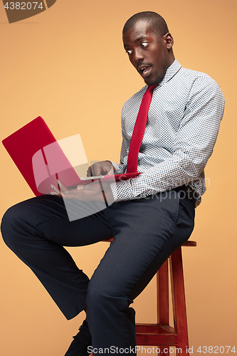 Image of Handsome Afro American man using a laptop