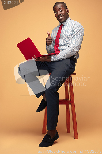 Image of Handsome Afro American man using a laptop